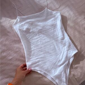 White bodysuit. New. Size XS. Thin, elegant straps.